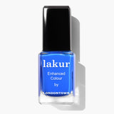 A bottle of LONDONTOWN's Lakur Enhanced Colour in vibrant electric blue, named "Iconic," boasts a black cap and white text on the label. This vegan, cruelty-free nail polish casts a shadow to the right and proudly features the 2019 Allure Best of Beauty Award.