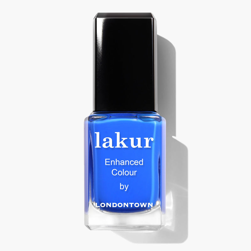 A bottle of LONDONTOWN's Lakur Enhanced Colour in vibrant electric blue, named "Iconic," boasts a black cap and white text on the label. This vegan, cruelty-free nail polish casts a shadow to the right and proudly features the 2019 Allure Best of Beauty Award.