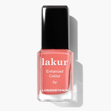 A bottle of Lakur Papaya nail polish with a black cap, labeled "Enhanced Colour by LONDONTOWN," featuring a vibrant pink shade. This vegan, 16+ free formula embodies both luxury and conscience.